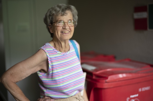 Judith Inskeep next to a recycle bin